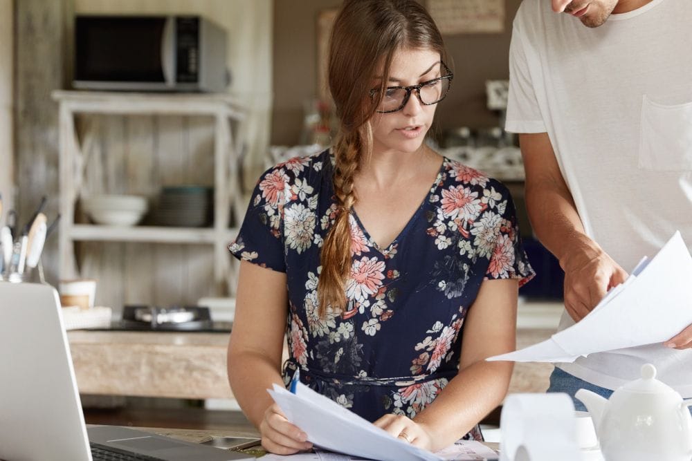 reviewing bills and financial documents together at home