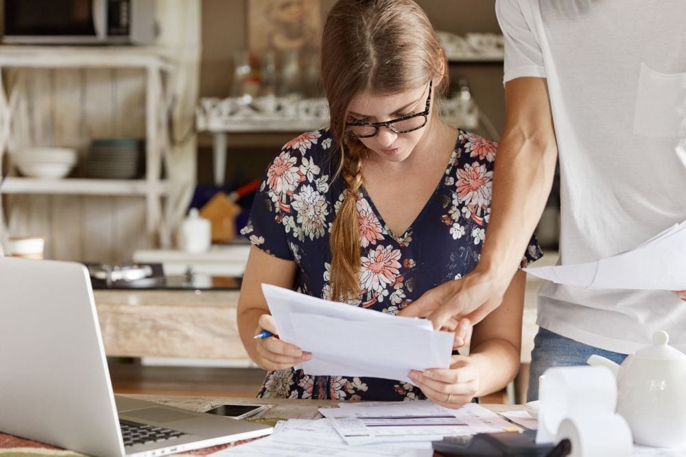 People reviewing bills wave alternatives and financial records while managing a budget