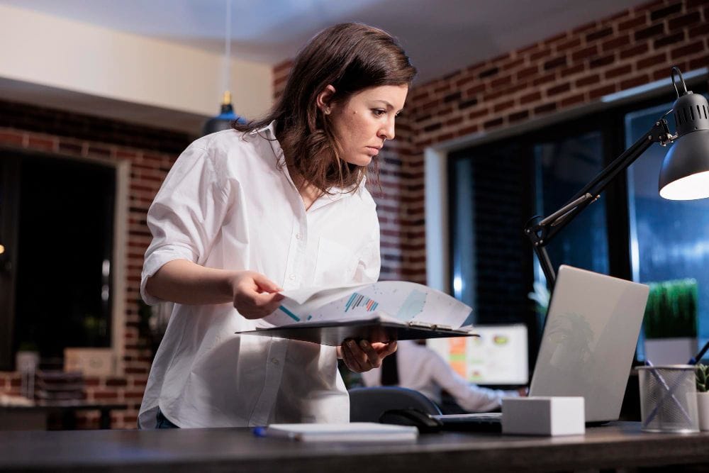 Business professional reviewing financial documents and charts