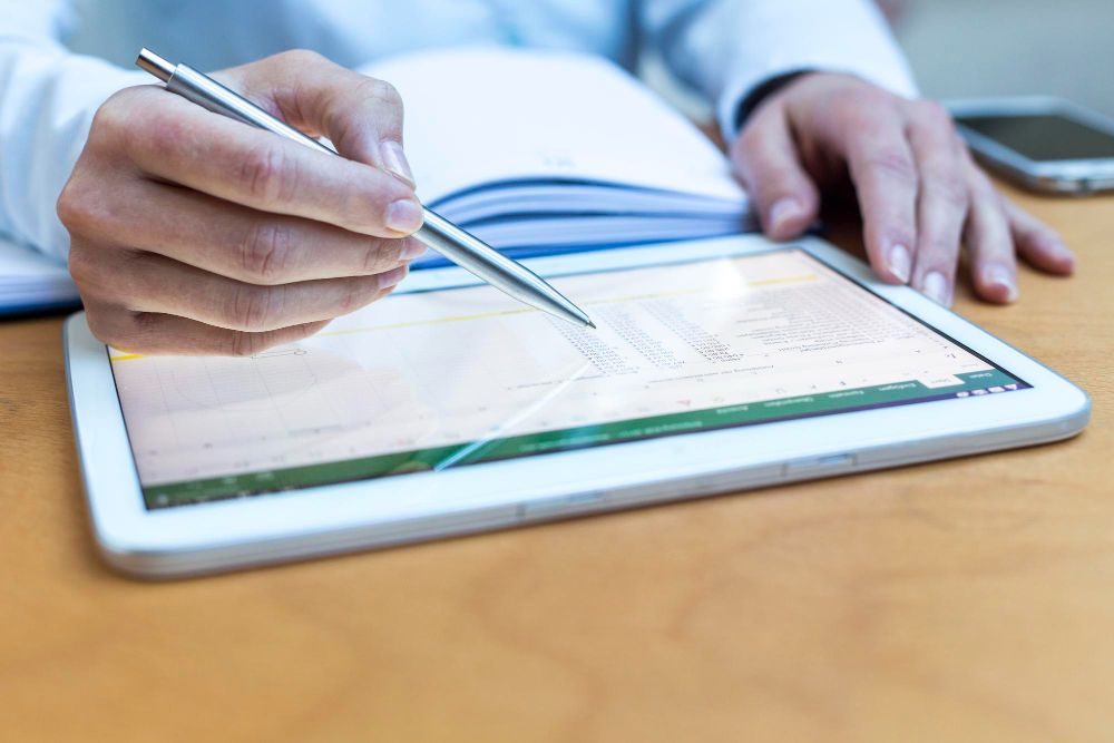 professional reviewing billing data on tablet